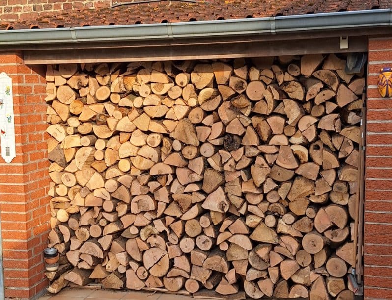 Bois rangé sous abri en briques